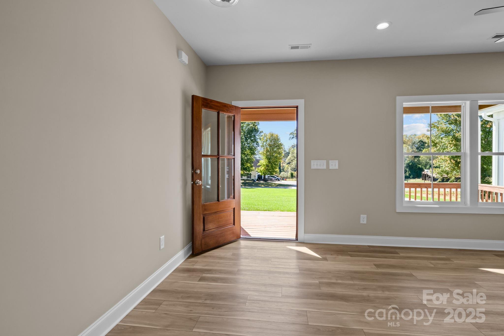 1716 Jennings Road Olin, NC 28660 - Photo 9 of 48 a view of an empty room with wooden floor and a window