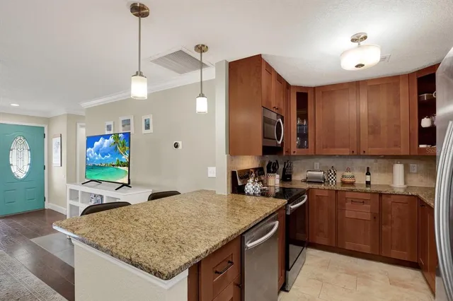 a kitchen with a stove a sink and a refrigerator