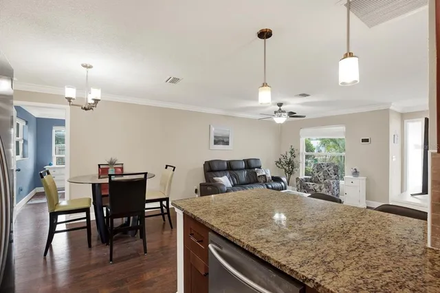 a view of a kitchen with a dining table and chairs