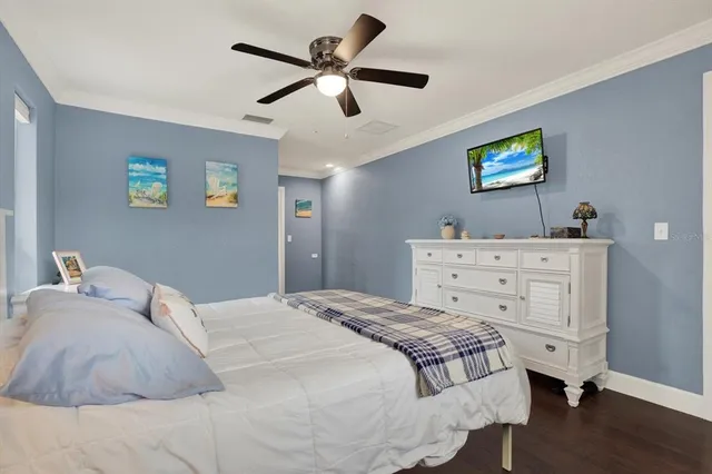 a bedroom with a bed and a ceiling fan