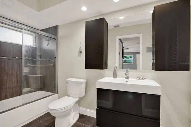 a bathroom with a sink toilet a mirror and shower