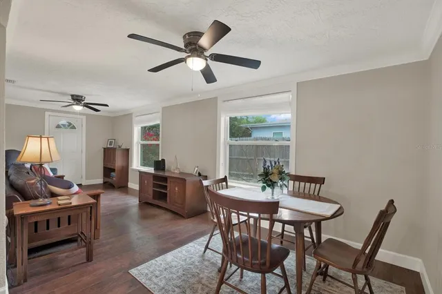 a view of a dining room with furniture window and wooden floor