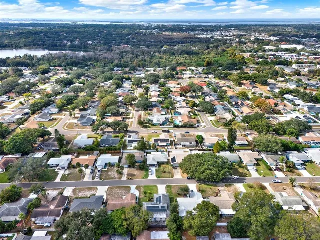 an aerial view of residential houses with city view
