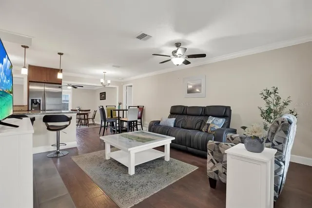 a living room with furniture and a chandelier