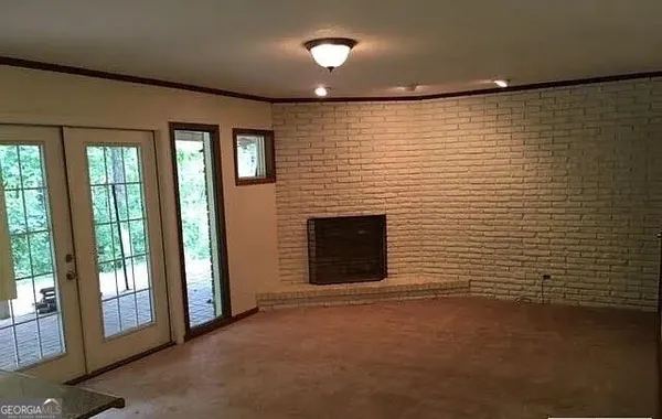 a view of an empty room with a fireplace