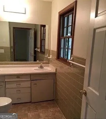 a bathroom with a double vanity sink and a mirror