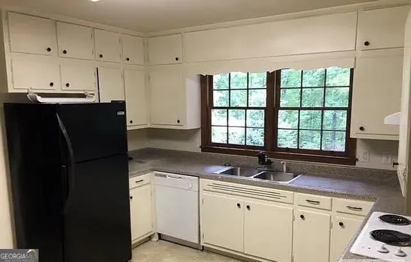 a kitchen with a sink window and cabinets