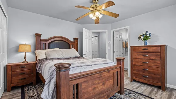 a bedroom with a bed and a dresser