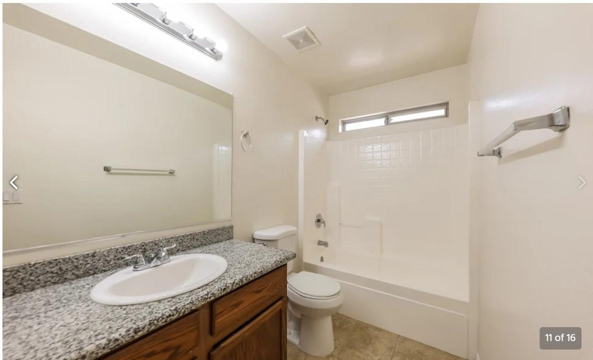 12563 West Charter Oak Road El Mirage, AZ 85335 - Photo 11 of 16 a bathroom with a granite countertop sink toilet mirror and shower