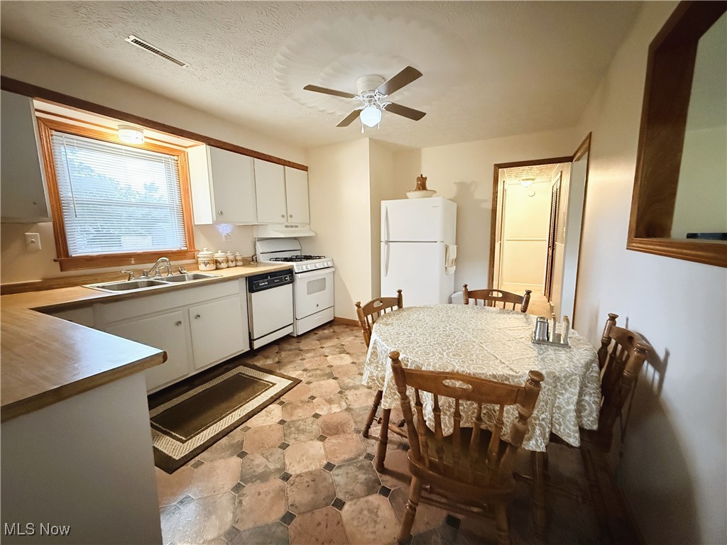 4185 Tapper Road Barberton, OH 44203 - Photo 7 of 23 Kitchen with white appliances, white cabinets, and ceiling fan