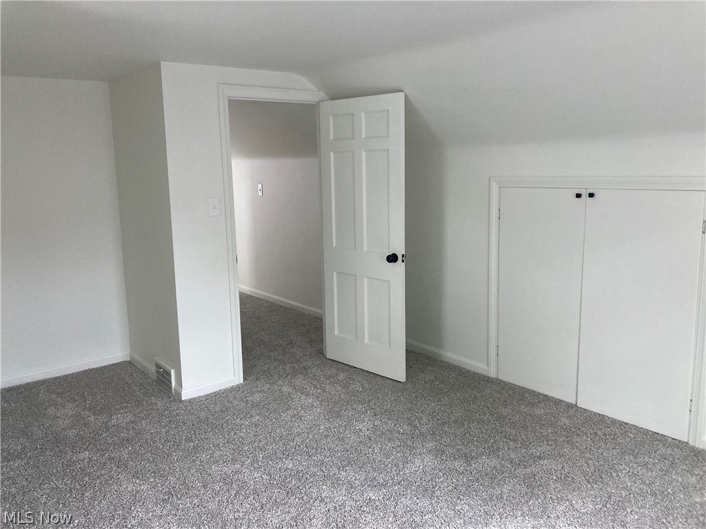 1407 Lander Road Cleveland, OH 44124 - Photo 21 of 33 Bonus room with lofted ceiling and carpet flooring