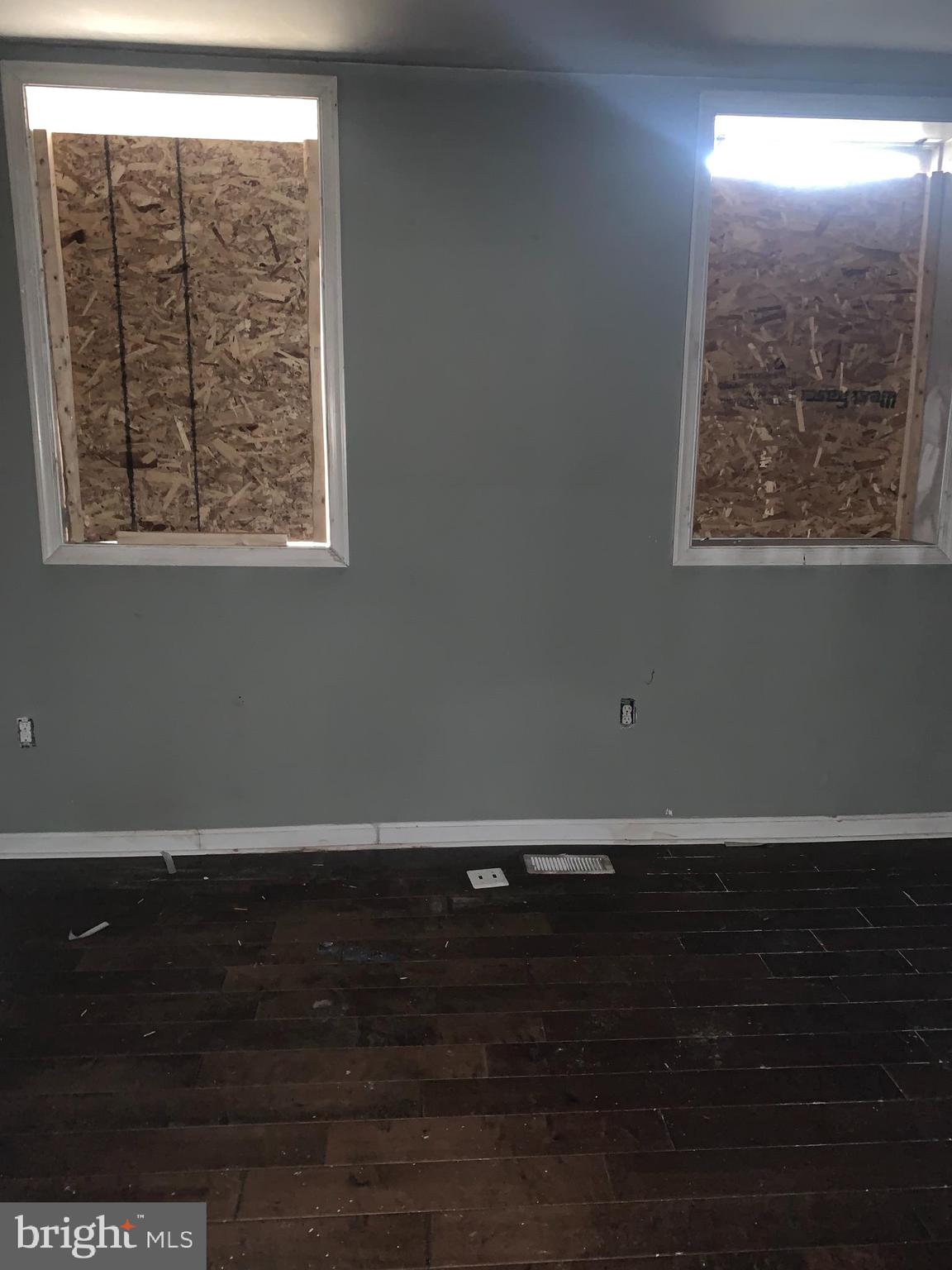 943 North Mount Street Baltimore, MD 21217 - Photo 2 of 11 an empty room with wooden floor and windows