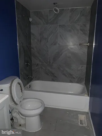 a bathroom with a toilet and a shower