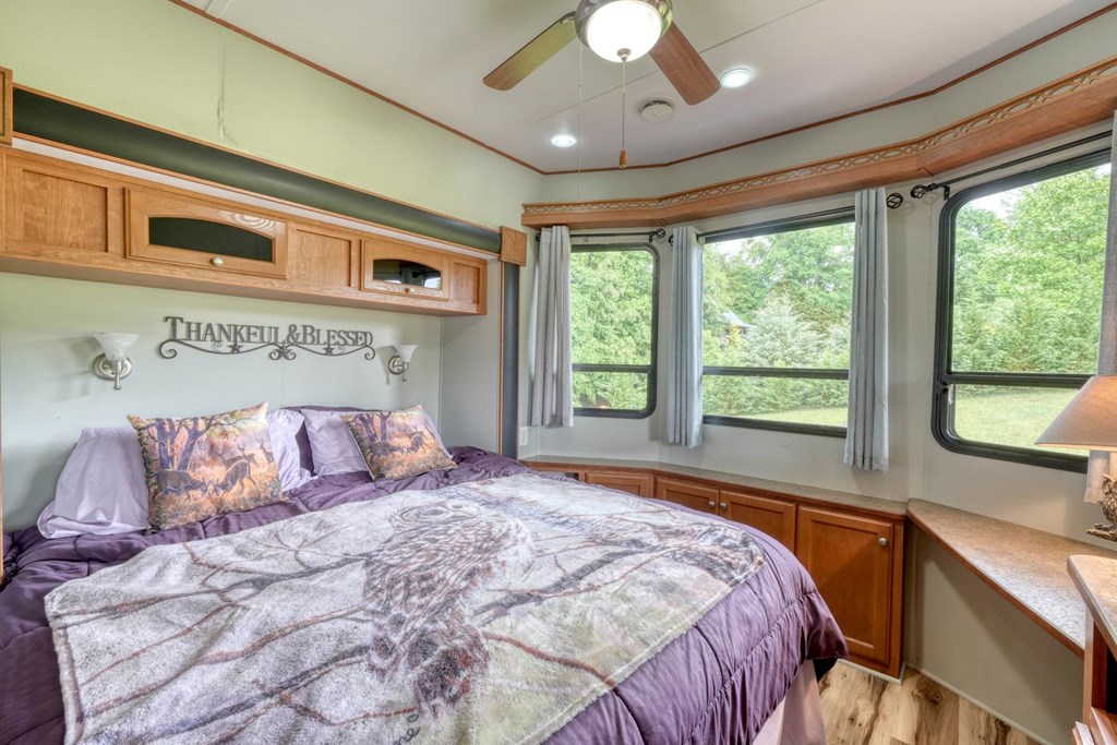 568 Parks Road Hiawassee, GA 30546 - Photo 19 of 38 a bedroom with a large bed and a large window