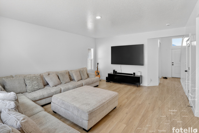 815 West Powderwood Lane Mapleton, UT 84664 - Photo 9 of 39 Living room with light wood-style flooring and a textured ceiling