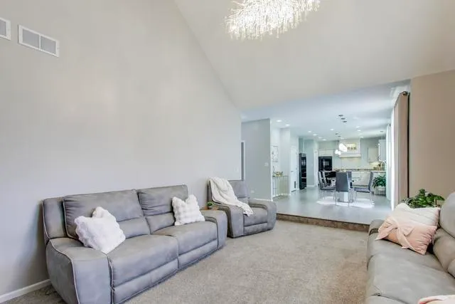 a living room with furniture a fireplace and a potted plant