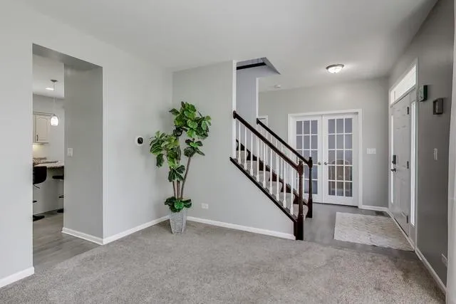 a kitchen with kitchen island granite countertop a sink stove and cabinets