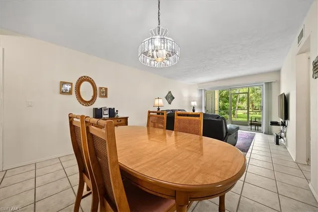 a kitchen with a sink and chairs