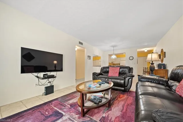 a living room with furniture and a lamp