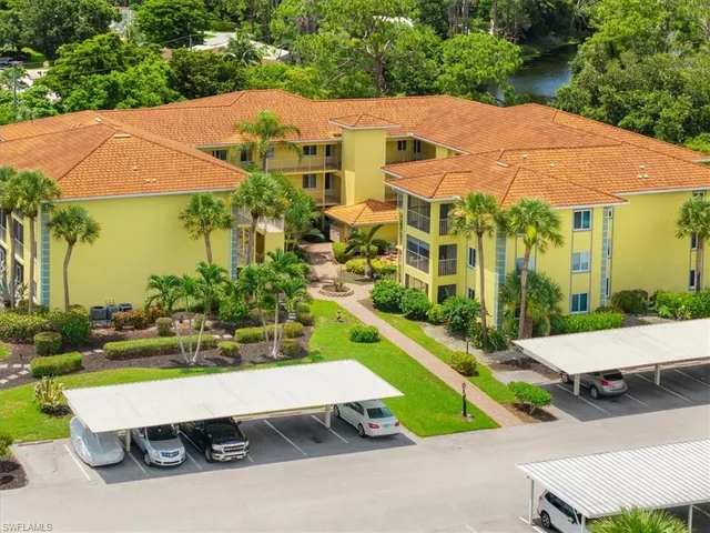 an aerial view of a house with a yard and outdoor seating