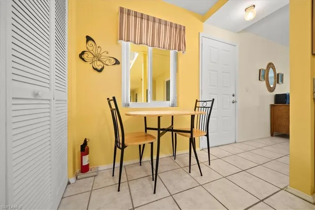 a view of a dining room with furniture and a window