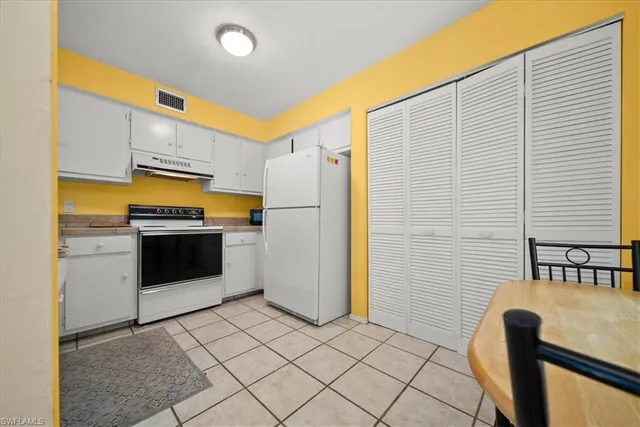 a kitchen with stainless steel appliances a refrigerator and a stove top oven