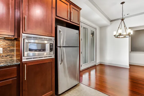 a metallic refrigerator freezer sitting in a kitchen