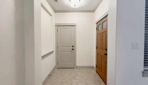 a view of a hallway with closet and refrigerator