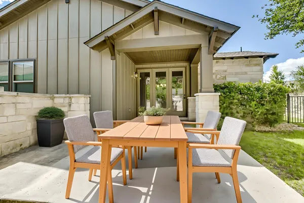 a view of a patio with table and chairs and potted plants
