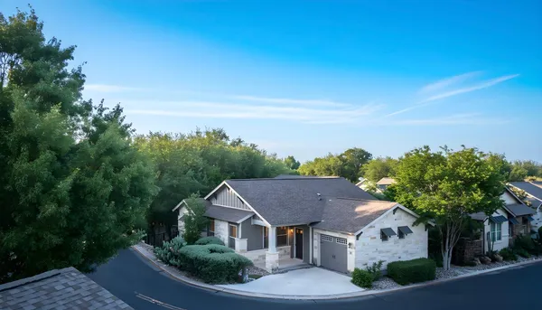 an aerial view of residential house with green space