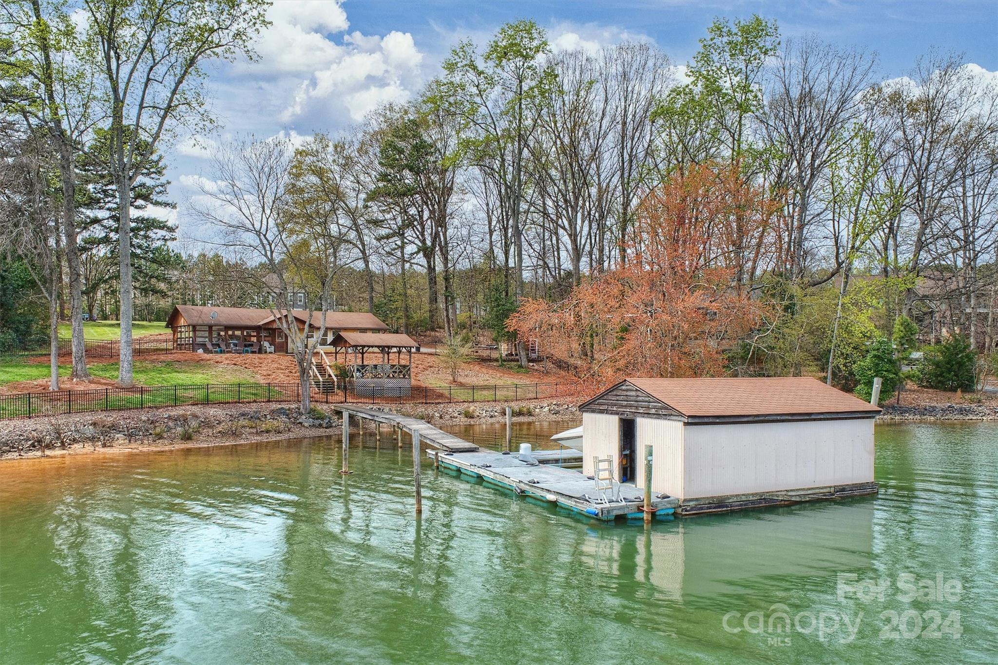 a view of a lake with a house in the background