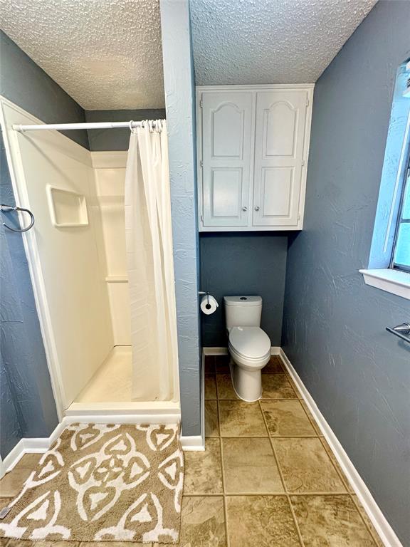 4170 Farm To Market 51 Decatur, TX 76234 - Photo 22 of 36 a bathroom with a toilet and a shower