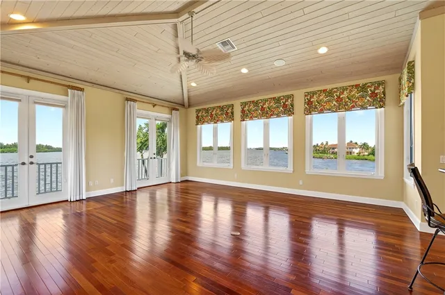 a kitchen with stainless steel appliances a refrigerator a sink dishwasher a stove and white countertops with wooden floor