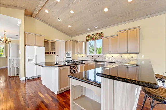 a large white kitchen with a large window