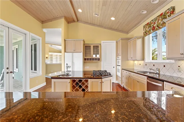 a kitchen with stainless steel appliances granite countertop a stove and a sink