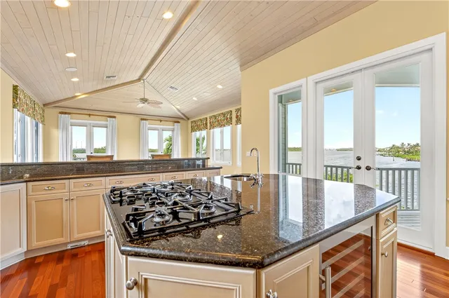 a kitchen with stainless steel appliances granite countertop a stove and a sink