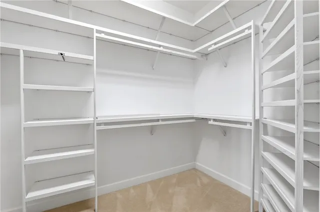 a view of an empty room with a fireplace and a window