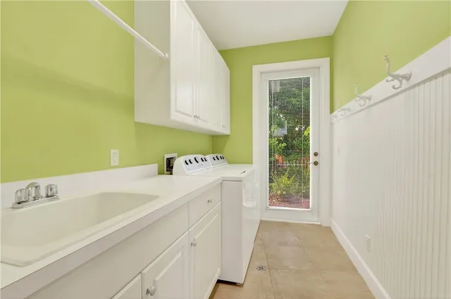 a view of an empty room with a window and a kitchen area