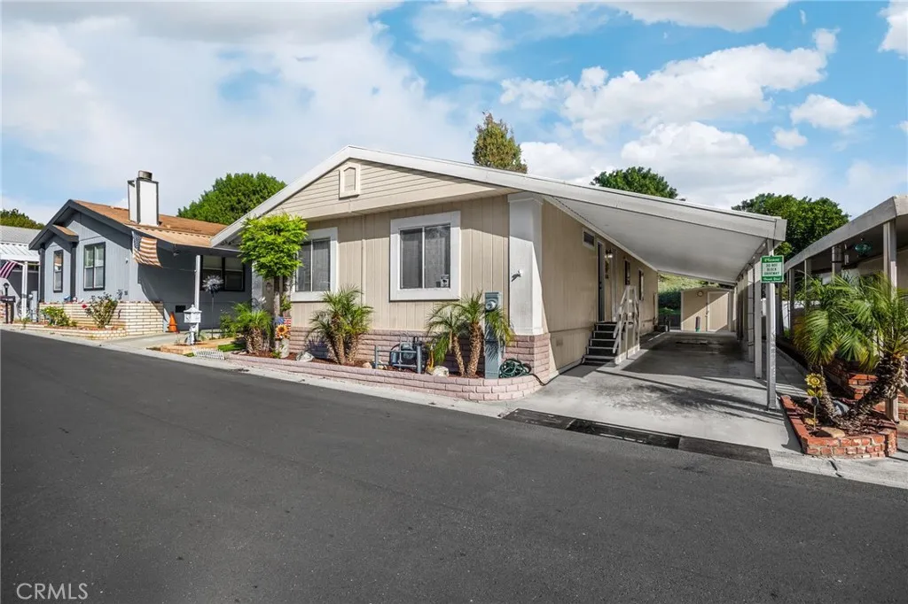 1051 Site, Unit 25 Brea, CA 92821 - Photo 1 of 1 a view of a white house with a dining space and a street