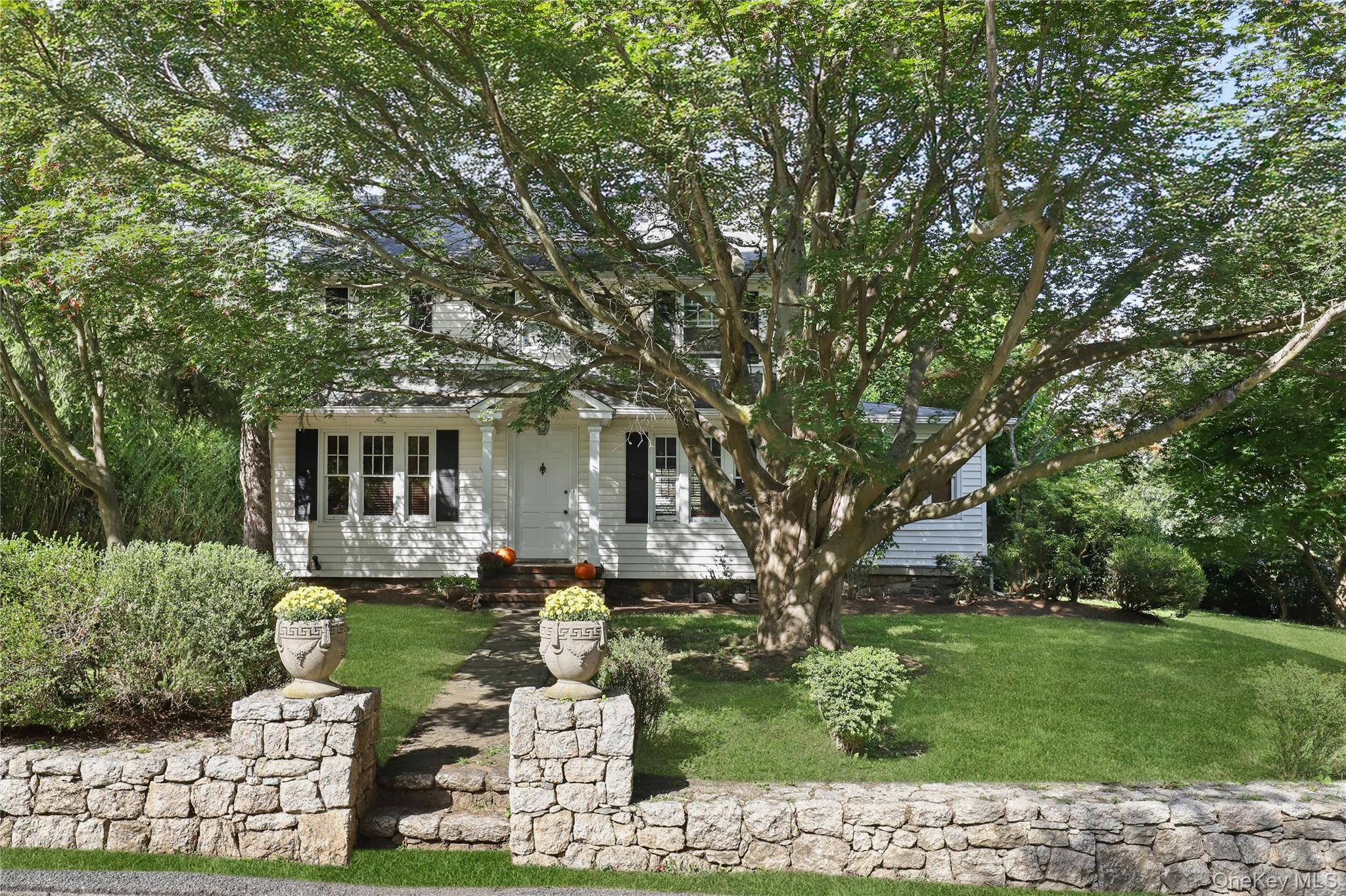 16 Annadale Street Armonk, NY 10504 - Photo 2 of 19 a front view of a house with garden