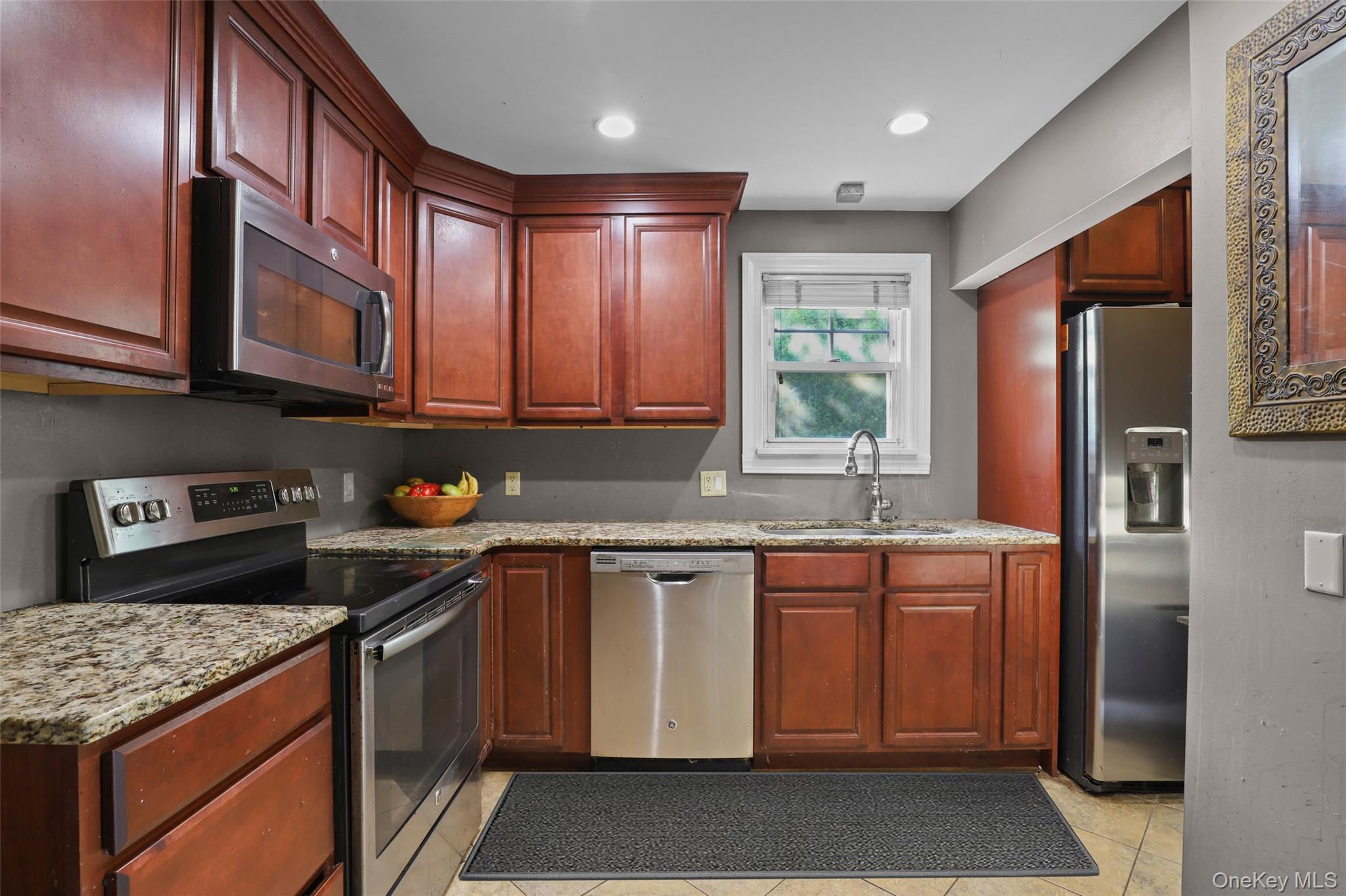 16 Annadale Street Armonk, NY 10504 - Photo 6 of 19 a kitchen with stainless steel appliances granite countertop a stove a sink dishwasher and a refrigerator