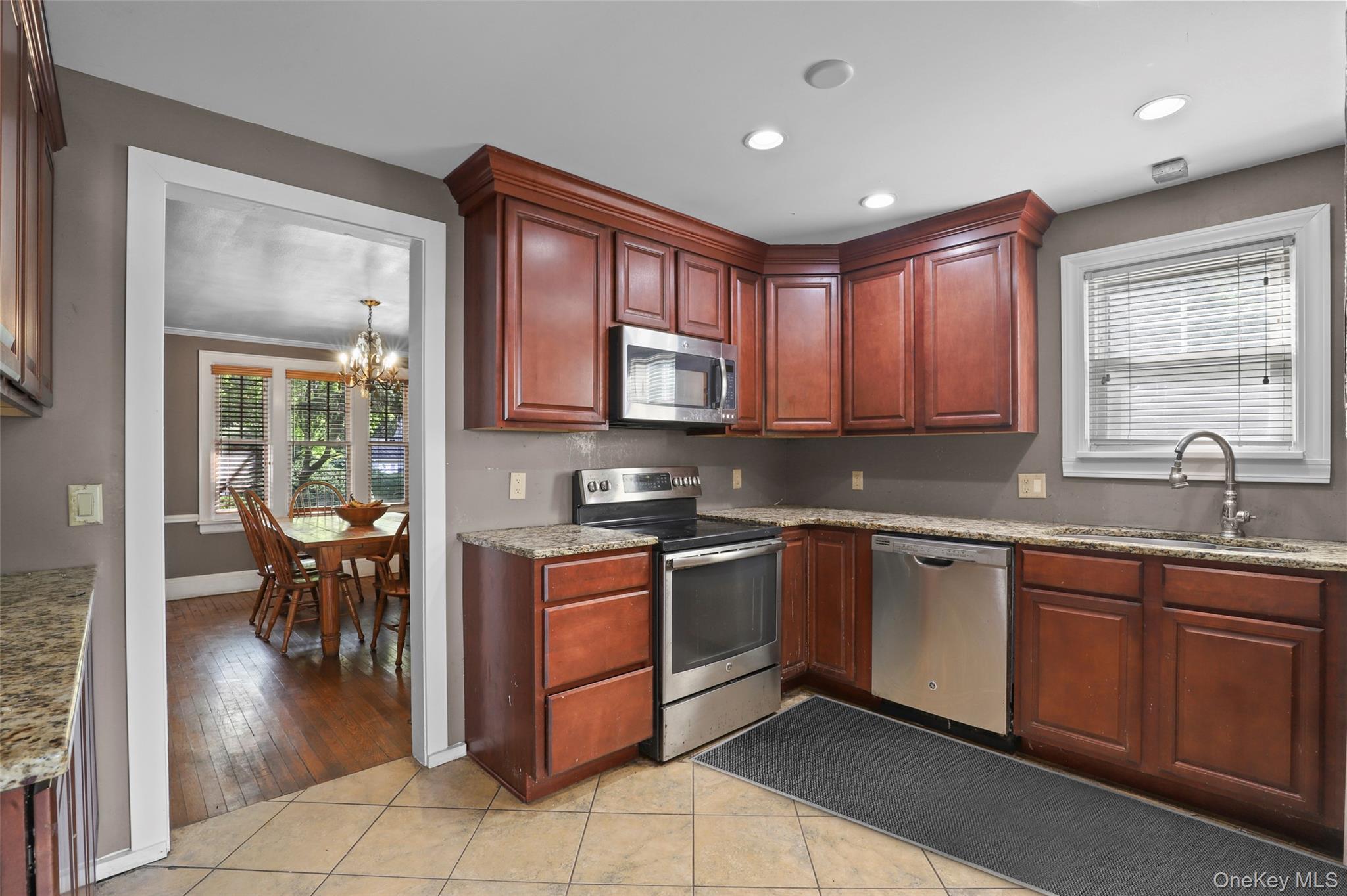 16 Annadale Street Armonk, NY 10504 - Photo 7 of 19 a kitchen with stainless steel appliances granite countertop sink stove and cabinets