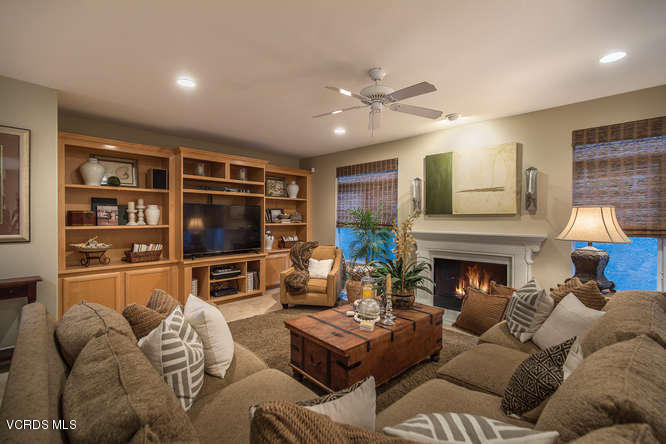 4145 Laurelview Drive Moorpark, CA 93021 - Photo 14 of 55 a living room with furniture a fireplace and a flat screen tv