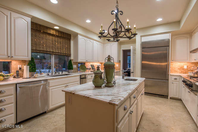 4145 Laurelview Drive Moorpark, CA 93021 - Photo 20 of 55 a kitchen with kitchen island granite countertop a center island stainless steel appliances cabinets and a counter top space