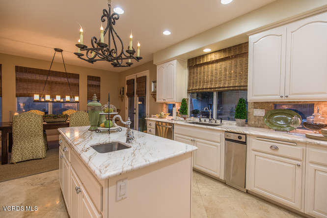4145 Laurelview Drive Moorpark, CA 93021 - Photo 23 of 55 a kitchen with kitchen island granite countertop a sink a counter space appliances and cabinets