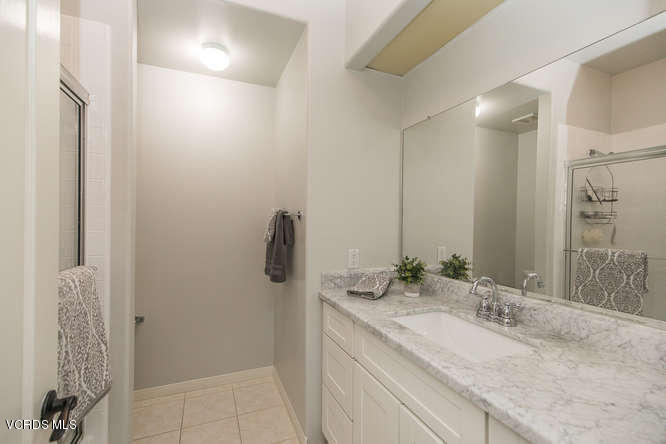 4145 Laurelview Drive Moorpark, CA 93021 - Photo 35 of 55 a bathroom with a granite countertop sink a shower and a mirror