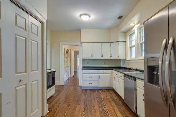 a kitchen with stainless steel appliances granite countertop a stove and a refrigerator