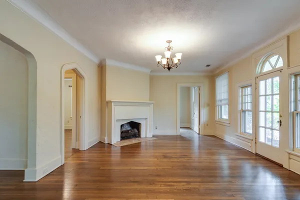a view of an empty room window and wooden floor