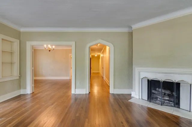 wooden floor fireplace and natural light in room