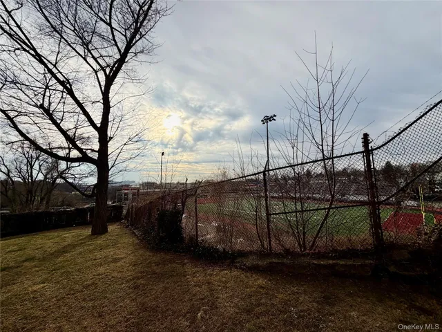 a view of an empty room with closet and entrance